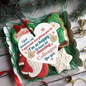 Macro detail of a heart-shaped wooden gift tag for colleagues in a festive Christmas gift box