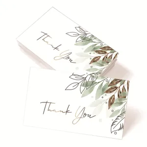 Elegant thank you cards with green and bronze leaf patterns on high-quality white paper