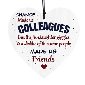 Detail of wooden heart plaque with emotional friendship quote and red heart accent