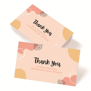 Close-up of thank you card with abstract geometric patterns and black polka dots