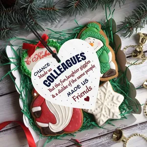 Detailed heart wooden tag with friendship quote in a festive Christmas gift box setting