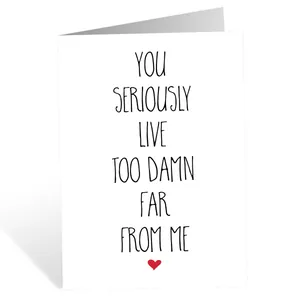 Detail of funny birthday card with bold black lettering and a small red heart on white paper