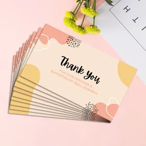 Close-up of minimalist pink and orange thank you cards for small business packaging