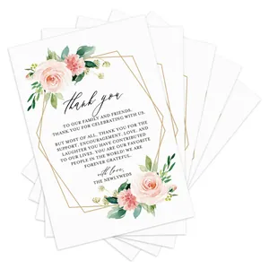 Detailed view of floral wedding thank you cards with gold borders and watercolor flowers