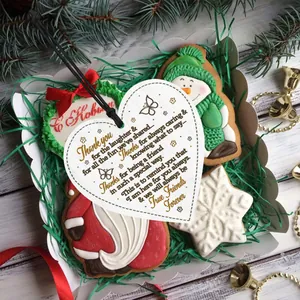 Detail of a heart wooden gift tag with friendship quote in a festive holiday box