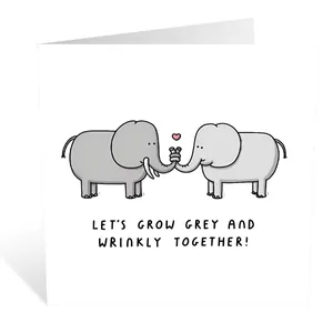 Close-up of white greeting card with cartoon elephants and Let's Grow Grey And Wrinkly text
