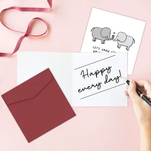 Detail of funny birthday card set with elephant illustration and deep red envelope