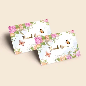 Detail of floral watercolor thank you cards with gold foil lettering on white paper