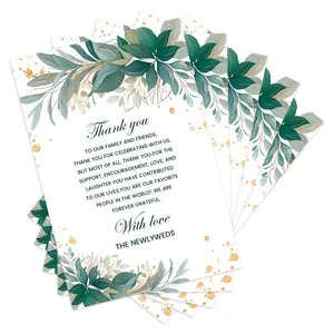 Detailed stack of floral wedding thank you cards with tropical green leaves and gold foil dots