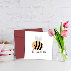Detail of creative birthday card with cute bee illustration and red envelope