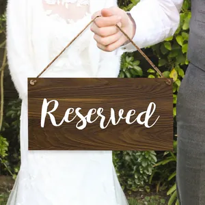 Rustic wooden Reserved wedding sign with elegant white calligraphy and hanging string