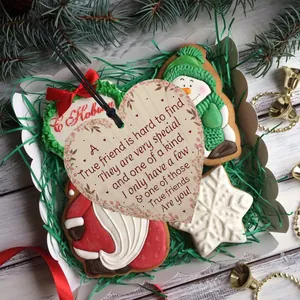 Detailed view of heart-shaped wooden gift tag with floral print in a festive gift box