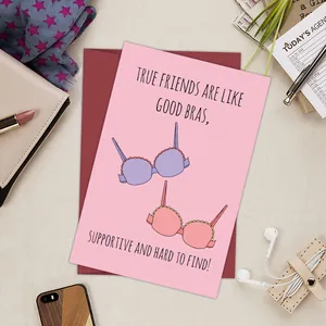 Close-up of funny bra greeting card with supportive friend quote on desktop
