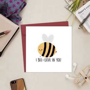 Funny bee-themed birthday card with red envelope and I Bee-lieve In You text