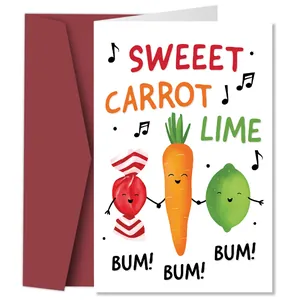 Macro view of funny greeting card featuring anthropomorphic carrot and lime illustrations