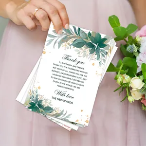 Floral wedding thank you cards with green leaves and gold accents for event table decor