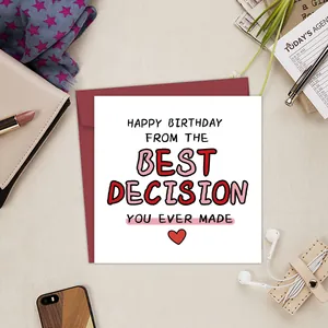 Flat lay of humorous birthday card with red envelope surrounded by stylish accessories