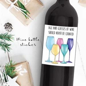 Detail of funny waterproof wine label with colorful glasses on a dark glass bottle