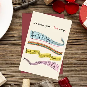 Carte de vœux romantique avec notes colorées et enveloppe rouge sur table en bois
