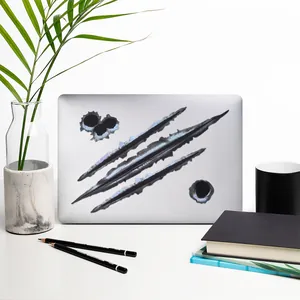3D claw marks and bullet holes stickers shown on a silver laptop lid for decor