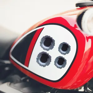 Realistic 3D bullet hole car stickers applied on red motorcycle gas tank for decoration