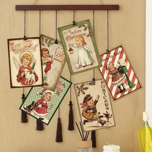 Set of 6 vintage Christmas decorative cards hanging on a wooden bar with tassels