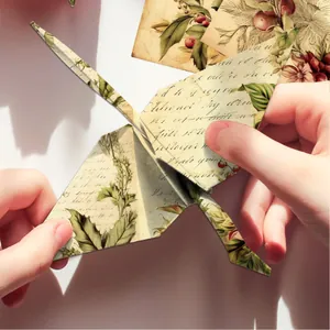 Retro floral scrapbooking paper folded into a crane for DIY craft projects