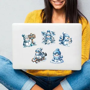 Detail of cute winter snowman decals on a laptop featuring festive North Pole designs