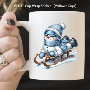 Detail of UV DTF cup wrap sticker featuring a cute blue snowman skiing on a white cup