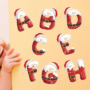 Detailed view of Christmas alphabet stickers featuring Santa motifs on yellow cardstock