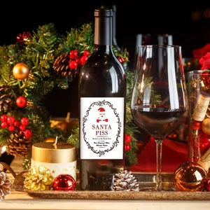 Close-up of Santa Piss joke wine label sticker applied to bottle with festive decor