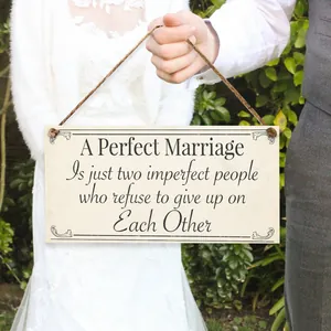 Wedding anniversary wooden plaque with marriage verses held by bride and groom