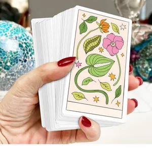 Hand hält tägliche Affirmationskarten mit botanischen Illustrationen für Achtsamkeit