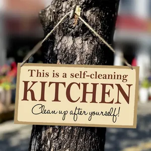 Detail of wooden kitchen sign hanging on a tree with rustic twine and humor quote