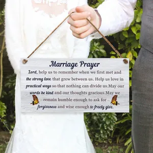 Close-up of a wooden Marriage Prayer plaque held by a groom in a wedding setting