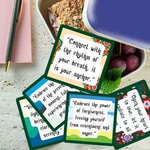 Set of 60 positive affirmation cards for women with floral patterns near a lunch box