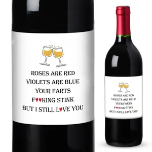 Detail of funny wine bottle stickers with poetic text and illustrations on dark glass