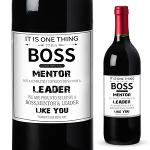 Macro detail of wine labels with appreciation quotes for leaders on a red wine bottle