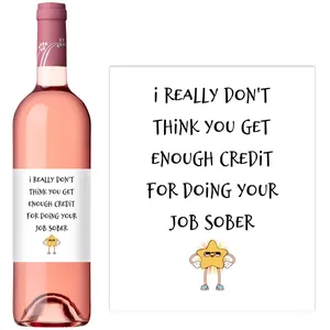 Detail of custom wine labels featuring funny cartoon star graphics on pink wine bottles