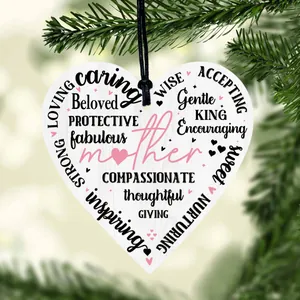 Heart-shaped wooden Mother's Day plaque with inspiring words on a green branch background