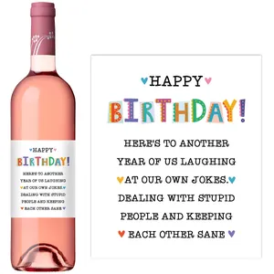 Detail of adhesive Happy Birthday wine bottle label with fun friendship message on rose wine