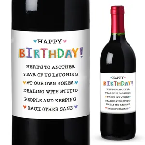Close-up and application of a funny Happy Birthday self-adhesive wine bottle label sticker