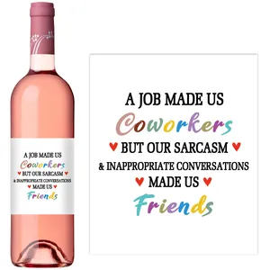 Detail view of custom humor wine labels on pink wine bottles with creative typography