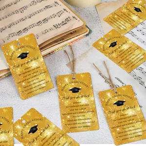 Close-up of rectangular graduation gift tags with gold glitter finish and jute twine strings