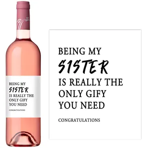 Detail showing self-adhesive sister gift label on a rose wine bottle with floral neck foil
