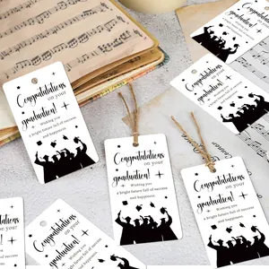 Detail of Graduation gift tags with silhouettes and twine on a vintage background