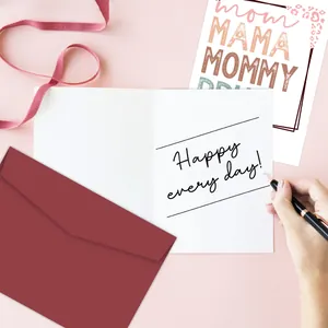 Macro shot of writing a Mother's Day card with leopard print and a deep red envelope