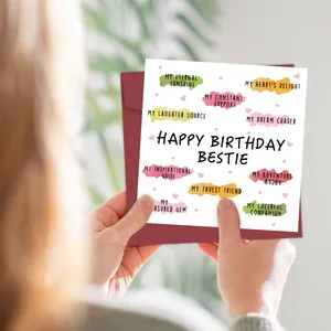 Dettaglio del biglietto d'auguri Bestie con bolle colorate tenuto tra le mani