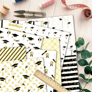 Close-up of graduation themed patterned paper with caps and diplomas for DIY scrapbooking