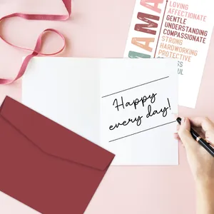 Close-up of Mother's Day greeting card set with red envelope and pink ribbon accents